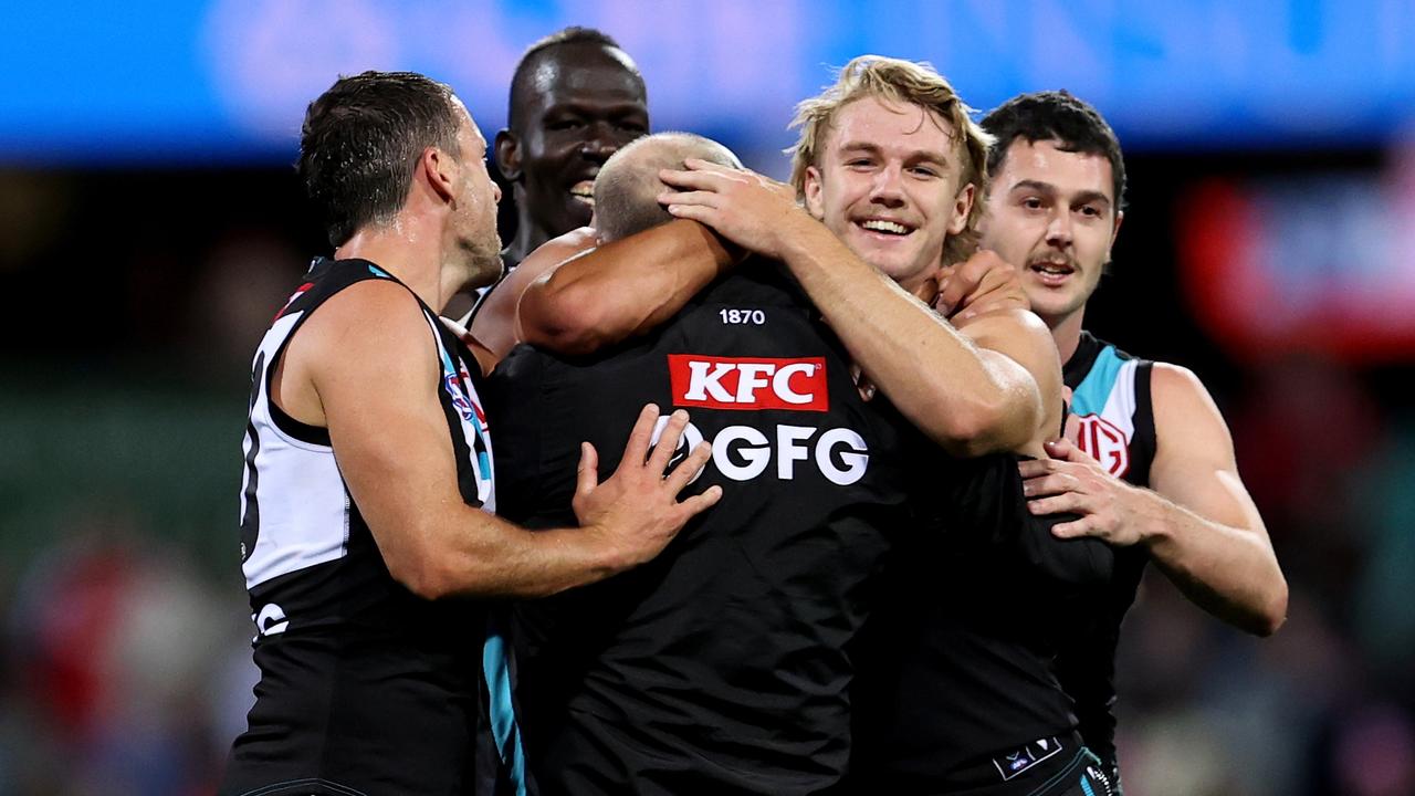 Power players embrace Ken Hinkley after the stirring comeback. (Photo by Brendon Thorne/AFL Photos/via Getty Images )