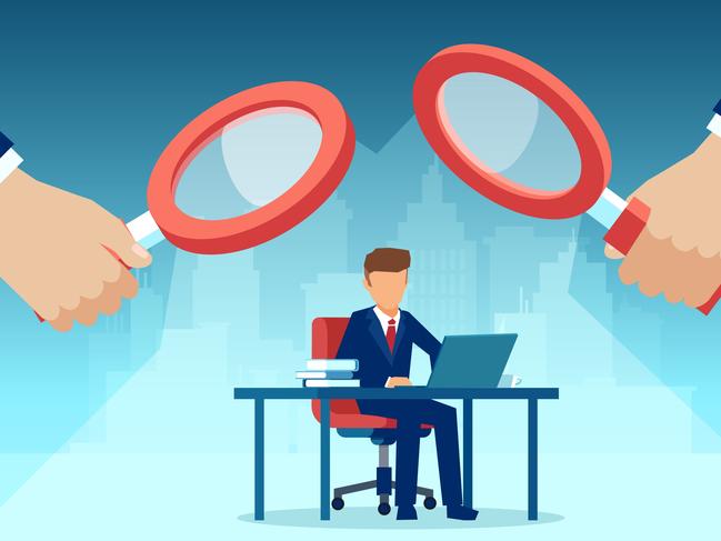 Vector of two managers with magnifying glass watching over at employee working at his desk on computer. Picture: iStock