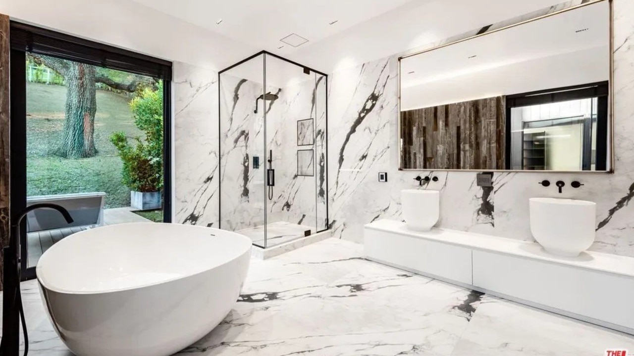 Gorgeous stone and a sculptural tub adorn a bathroom. Picture: Realtor.com