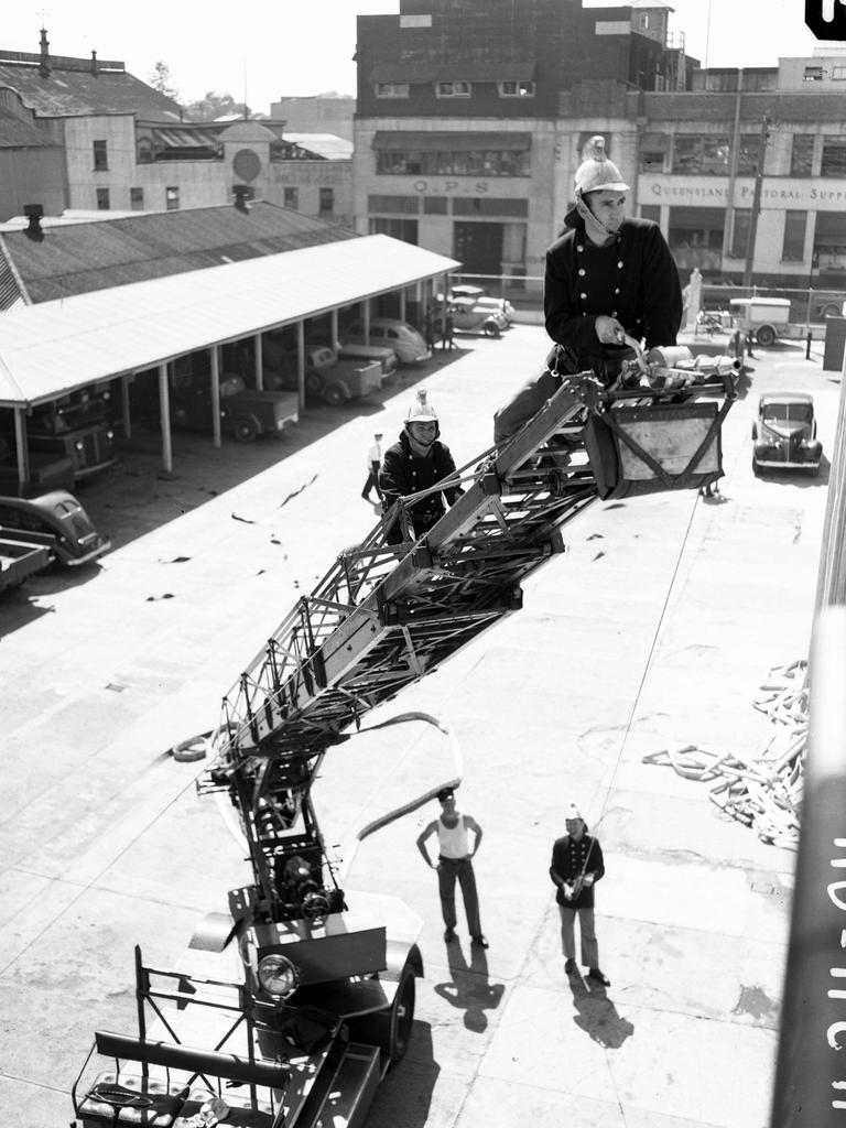 Firemen doing training on an extension ladder in Brisbane in the 1950s.