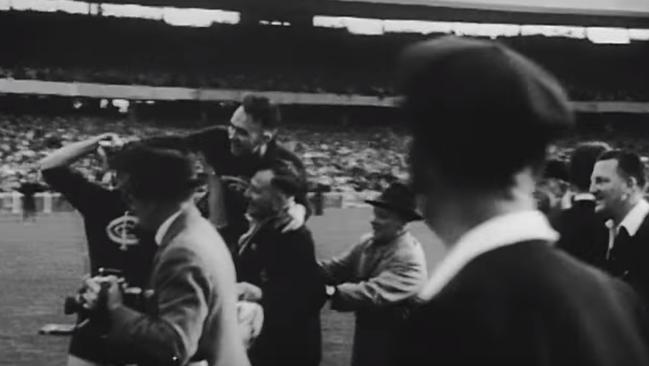 Carlton players and officials celebrate the one-point victory. Picture: National Film and Sound Archive