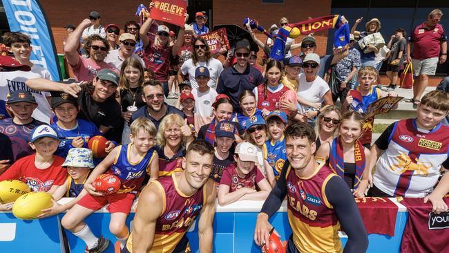 Josh Dunkley and Jarrod Berry surrounded by Lions fans. Picture Lachie Millard