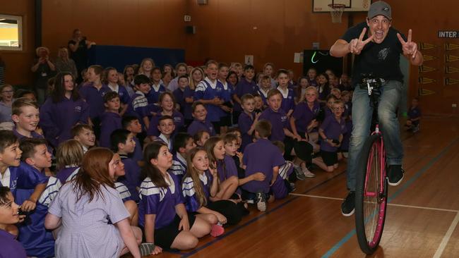 Samuel Johnson on his unicycle doing laps of Yarra Road Primary School’s gym. Picture: George Salpigtidis