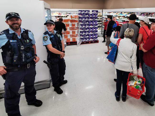 Police were on hand to watch over the queue. Picture: AAP/James Gourley