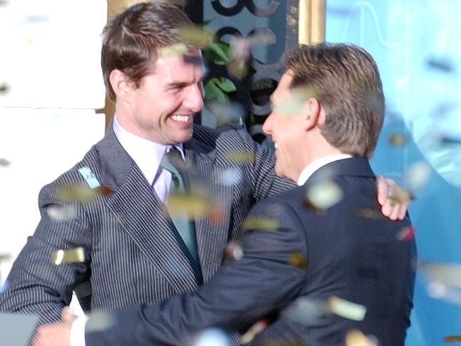 Confetti rains down as actor Tom Cruise embraces David Miscavige, the Scienology Church's President of the Ruling Council during the official opening of a new Scientology church in central Madrid in 2004.