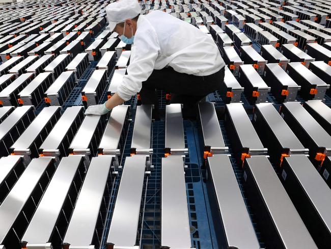 (FILES) This file photo taken on March 12, 2021 shows a worker with car batteries at a factory for Xinwangda Electric Vehicle Battery Co. Ltd, which makes lithium batteries for electric cars and other uses, in Nanjing in China's eastern Jiangsu province. - Lithium, cobalt and nickel, the metals that are essential to the manufacture of the electric batteries that will replace the combustion engines that contribute to global warming, are so sought after that Europe is preparing to open mines and refineries to try to reduce its dependence on imports. (Photo by AFP) / China OUT