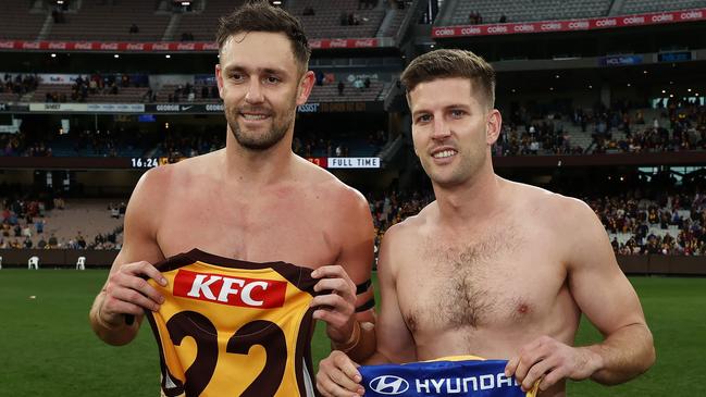 Jack Gunston of the Lions and Luke Breust of the Hawks swap jumpers. Picture: Michael Klein