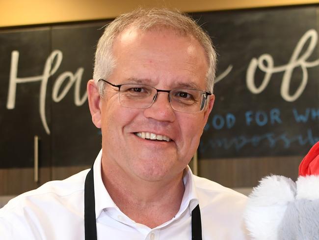 BRISBANE, AUSTRALIA - NewsWire Photos - DECEMBER 21, 2021. Australian Prime Minister Scott Morrison packs a Christmas hamper to be donated by the charity Hands of Hope ahead of Christmas. Picture: NCA NewsWire / Dan Peled