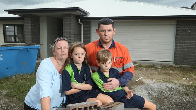 Martin Sorrell, wife Kristi Sorrell and children, Sasha 8 and Marcus 7, in front of their partially built home at Ormeau Hills. Kristi and her family were building with Future Urban Residential, which is now unlicensed and their home is unfinished. Picture: Glenn Hampson