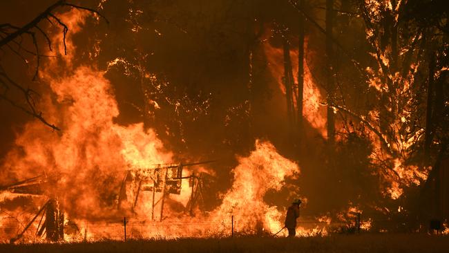 NSW Rural Fire Service crews fight the Gospers Mountain Fire as it reaches a structure at Bilpin on Saturday. Picture: AAP