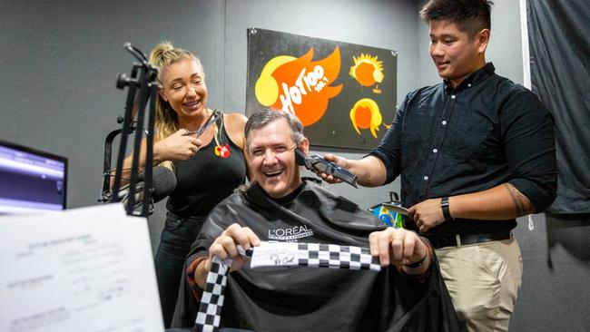 Dannii from Hot 100, the Chief Minister Michael Gunner holding his signed bandana from Pat Cash and Matthew Lee the barber in the studio. Picture: Floss Adams.