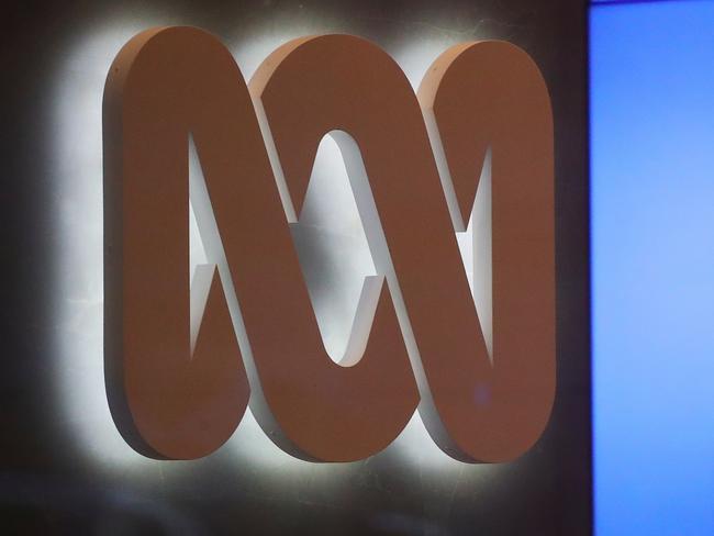 The logo of the ABC can be seen next to a screen displaying news stories at the main entrance to the ABC building located at Ultimo in Sydney, Wednesday, June 5, 2019. Federal police officers have raided ABC's Sydney offices over stories published in 2017 that suggested Australian troops may have committed war crimes. (AAP Image/David Gray) NO ARCHIVING