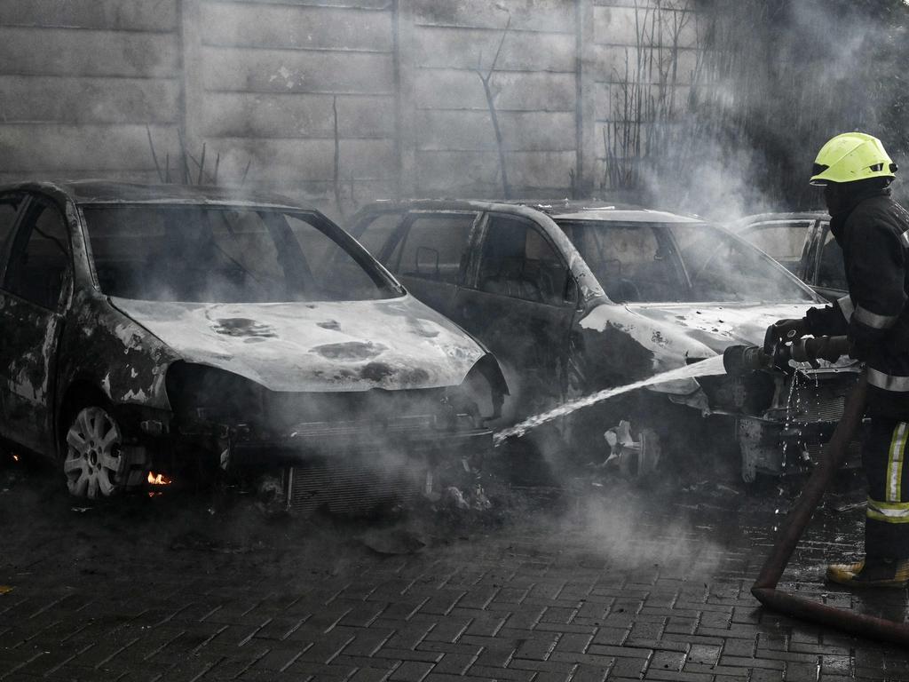 A firefighter extinguishes burning vehicles in Nairobi. Picture: AFP