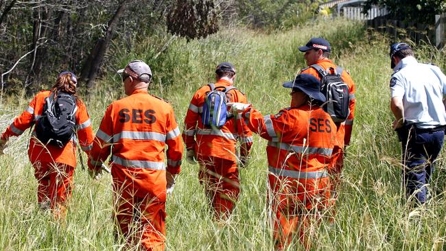 Police and SES members searching bushland behind the Chardon house at Coomera in 2013.