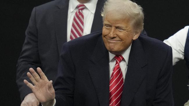 PHILADELPHIA, PENNSYLVANIA - MARCH 22: U.S. President Donald Trump salutes the crowd during the 2025 NCAA Division I Men's Wrestling Championship at the Wells Fargo Center on March 22, 2025 in Philadelphia, Pennsylvania.   Mitchell Leff/Getty Images/AFP (Photo by Mitchell Leff / GETTY IMAGES NORTH AMERICA / Getty Images via AFP)