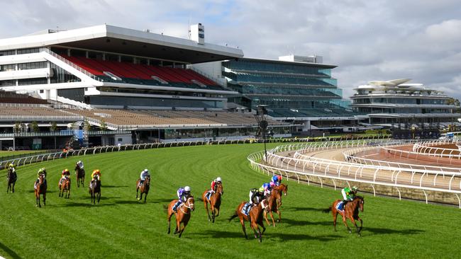 MELBOURNE, AUSTRALIA - OCTOBER 31: Jockey Hugh Bowman riding Fiesta (ctr white cap) to win Race 9, the Furphy Sprint,  during 2020 AAMI Victoria Derby Day at Flemington Racecourse on October 31, 2020 in Melbourne, Australia. (Photo by Vince Caligiuri/Getty Images for the VRC)