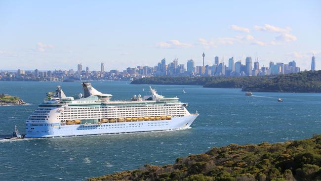 The Voyager of the Seas entering Sydney Harbour for restocking and transferring of crew before departing for its home port due to COVID-19 rules.