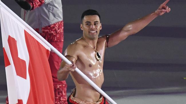 Pita Taufatofua carries the flag of Tonga during the opening ceremony of the 2018 Winter Olympics in Pyeongchang, South Korea, Friday, Feb. 9, 2018. (Franck Fife/Pool Photo via AP)