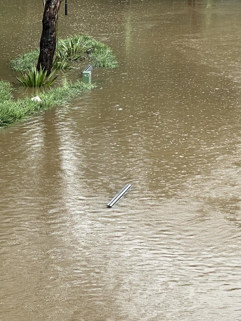 A park bench is almost entirely covered in water at the Parramatta River on Monday.