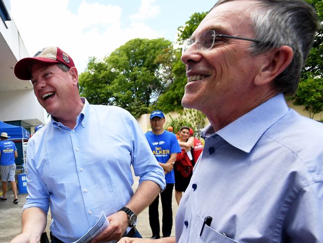 Queensland Opposition leader Tim Nicholls (centre) with LNP MP Ian Walker (right) hand out how-to-vote cards in Upper Mt Gravatt, Brisbane, during the Queensland Election campaign on Friday, November 24, 2017. Mr Nicholls is campaigning in the electorate of Mansfield, currently held by LNP MP Ian Walker. (AAP Image/Tracey Nearmy) NO ARCHIVING