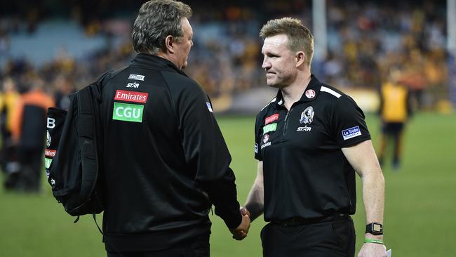 Neil Balme and Collingwood coach Nathan Buckley shake hands after the club’s Round 23 loss. Picture: Getty Images.