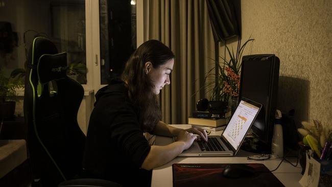 A woman checks the schedule for planned power cuts in her area on energy company DTEKs website in Kyiv. Picture: Getty Images