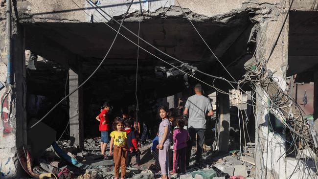 Palestinian children at a building destroyed by Israeli bombardment the previous night in Rafah in the southern Gaza Strip this week during the war with Hamas. Picture: Mohammed Abed/AFP