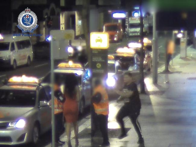 A man appears to run at a security guard from behind. Picture: NSW Police