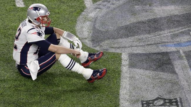 New England Patriots quarterback Tom Brady sits on the field after fumbling. Picture: AP.