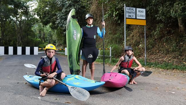 Recreational kayakers are angry that the Barron Gorge Road at Caravonica remains closed to traffic, more than 10 months on from the flood. Junior kayakers Teddy Berry, 9, Angus Gonzo, 11, and Kitty Berry, 11, used to train frequently on the Barron River. Now, their closest training zone outside of the wet season is the Tully River, over two hours south of Cairns. Picture: Brendan Radke