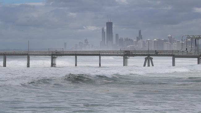 Tourists and locals watch on as giant surf pounds Gold Coasts northern beaches. Picture Glenn Hampson
