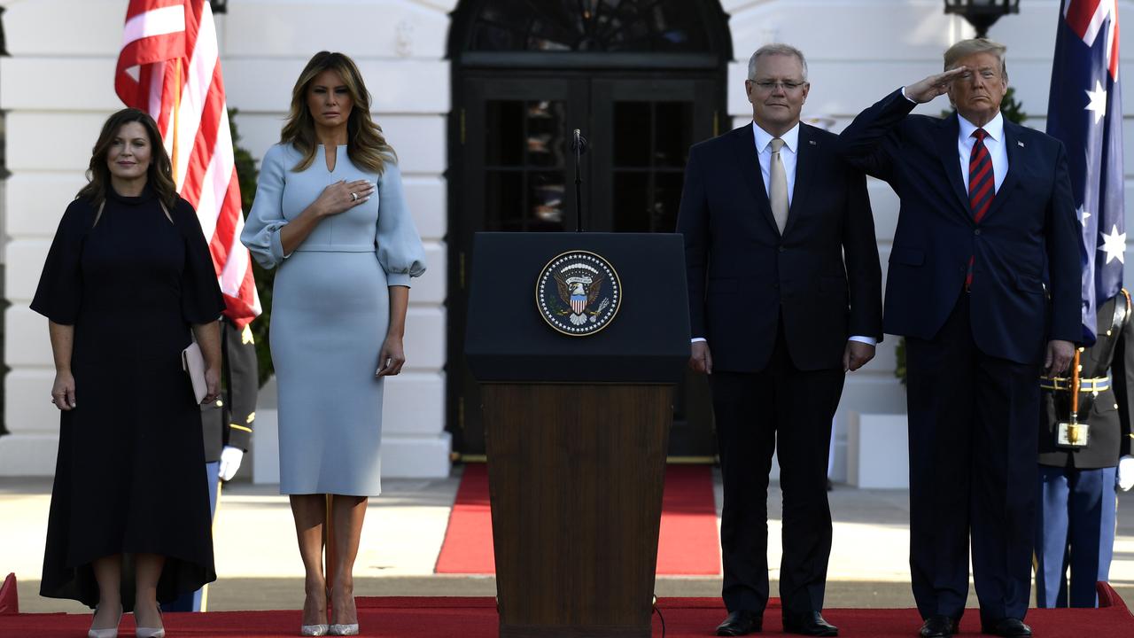 US President Donald Trump and first lady Melania Trump stand for the US National Anthem with Australian Prime Minister Scott Morrison and his wife Jenny Morrison. Picture: AP/ Susan Walsh.