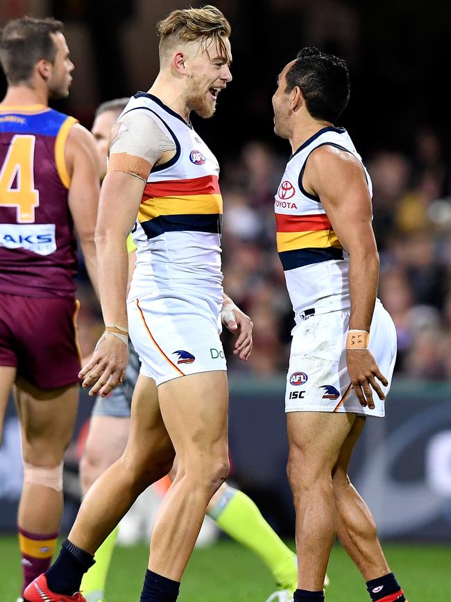 Adelaide’s Hugh Greenwood celebrates with Eddie Betts after kicking a goal at The Gabba. Picture: Bradley Kanaris/Getty Images