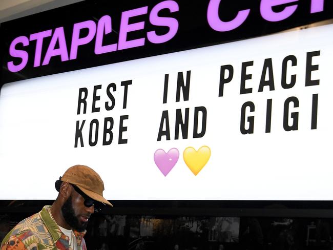 LeBron James, number 23 of the Los Angeles Lakers, arrives for the game against the Portland Trail Blazers as he passes a sign to honour Kobe and Gigi Bryant. Picture; Getty Images