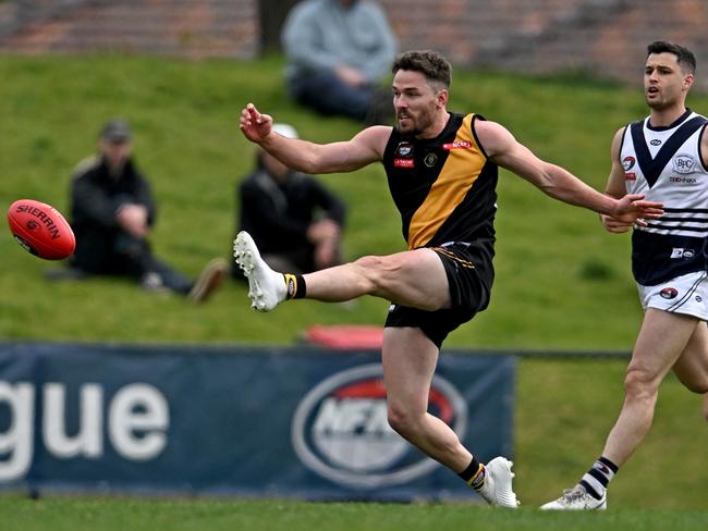 Smith launches a clearing kick. Picture: Andy Brownbill