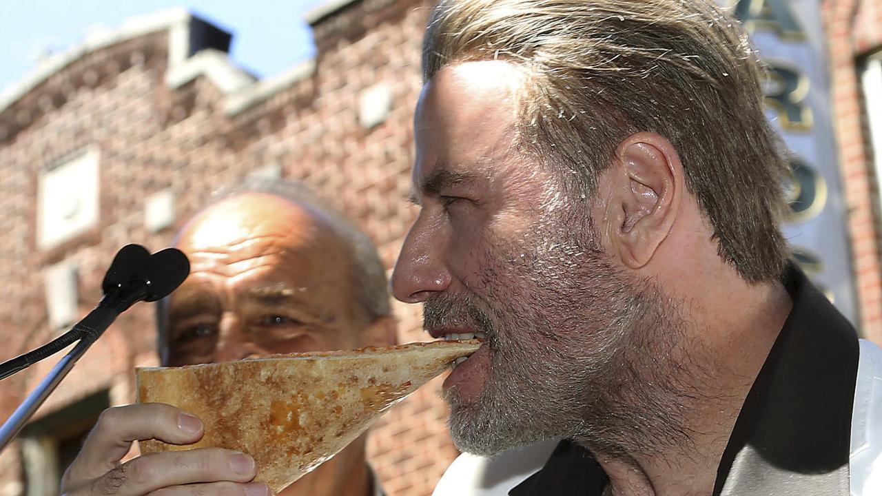 But not John Travolta, he knows how it’s done. Here the “Gotti” star is enjoying a slice of pizza from Lenny’s Pizzeria in New York on Tuesday. The pizzeria was highlighted in the 1977 blockbuster “Saturday Night Fever”.