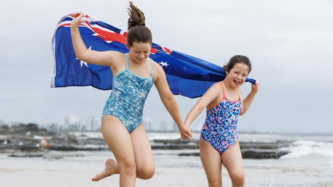 Sisters Milly, 10, and Jemima Gall 8, from Crooble, NSW, enjoying Australia Day at Mooloolaba Beach. Picture Lachie Millard