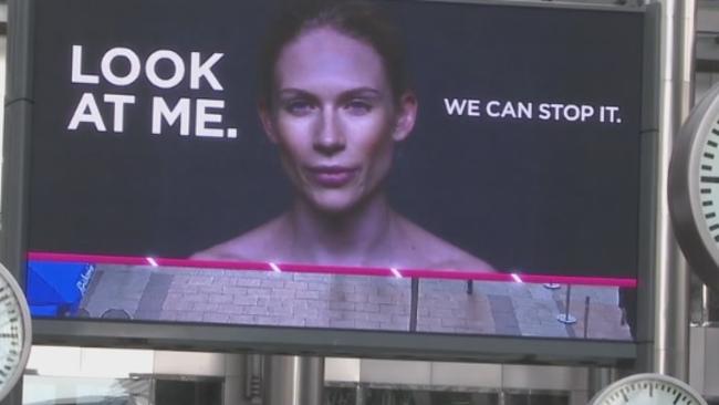 The woman in the billboard thanks passers by for looking.