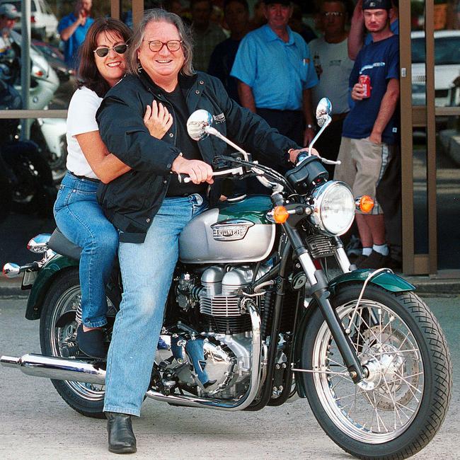 Doug Mulray with his wife picking up a new motorbike in 2000. Picture: Peter Clark