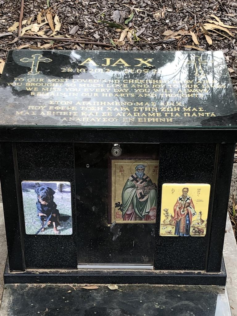 Ajax the rottweiler rests in peace surrounded by orthodox iconography.