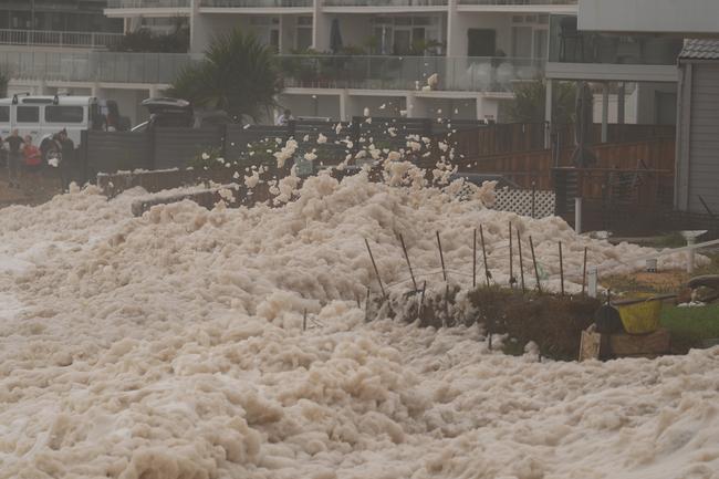 Foam is threatening to cover the homes damaged in the 2016 storms at Collaroy. Picture: John Grainger