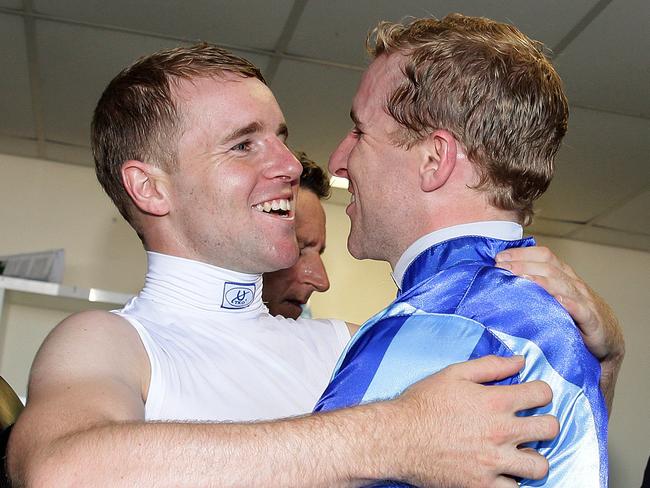 Jockey Nathan Berry rides no1 Unencumbered to the win in the Magic Millions 2YO Classic on the Gold Coast and is hugged by twin brother Tommy Berry as he enters the Jockeys room. Pics Adam Head