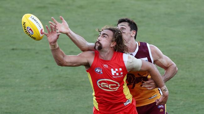 Brayden Crossley of the Suns and Oscar McInerney of the Lions compete for the ball. Picture: Getty Images