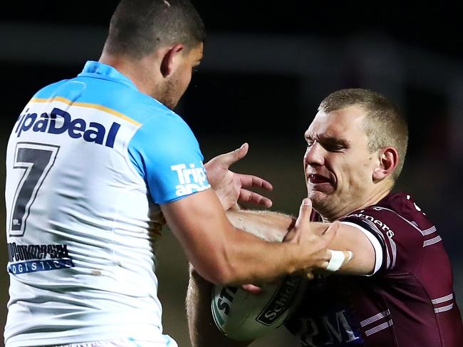 SYDNEY, AUSTRALIA - AUGUST 17: Ashley Taylor of the Titans is fended away by Tom Trbojevic of the Sea Eagles during the round 23 NRL match between the Manly Sea Eagles and the Gold Coast Titans at Lottoland on August 17, 2018 in Sydney, Australia. (Photo by Mark Kolbe/Getty Images)