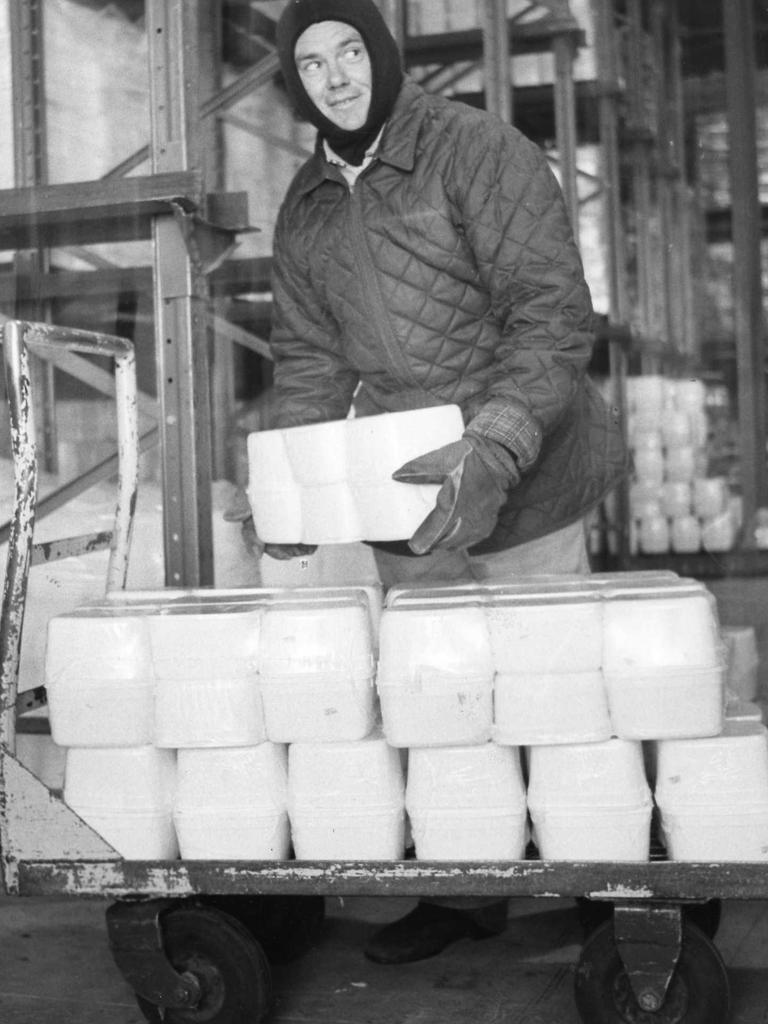 An AMSCOL icecream factory worker loads tubs of icecream on to trolly at the Carrington St factory.