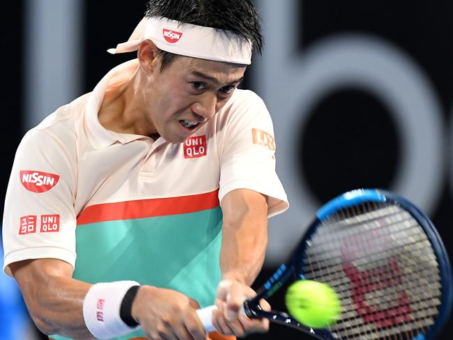 Kei Nishikori plays a backhand in the men’s final.