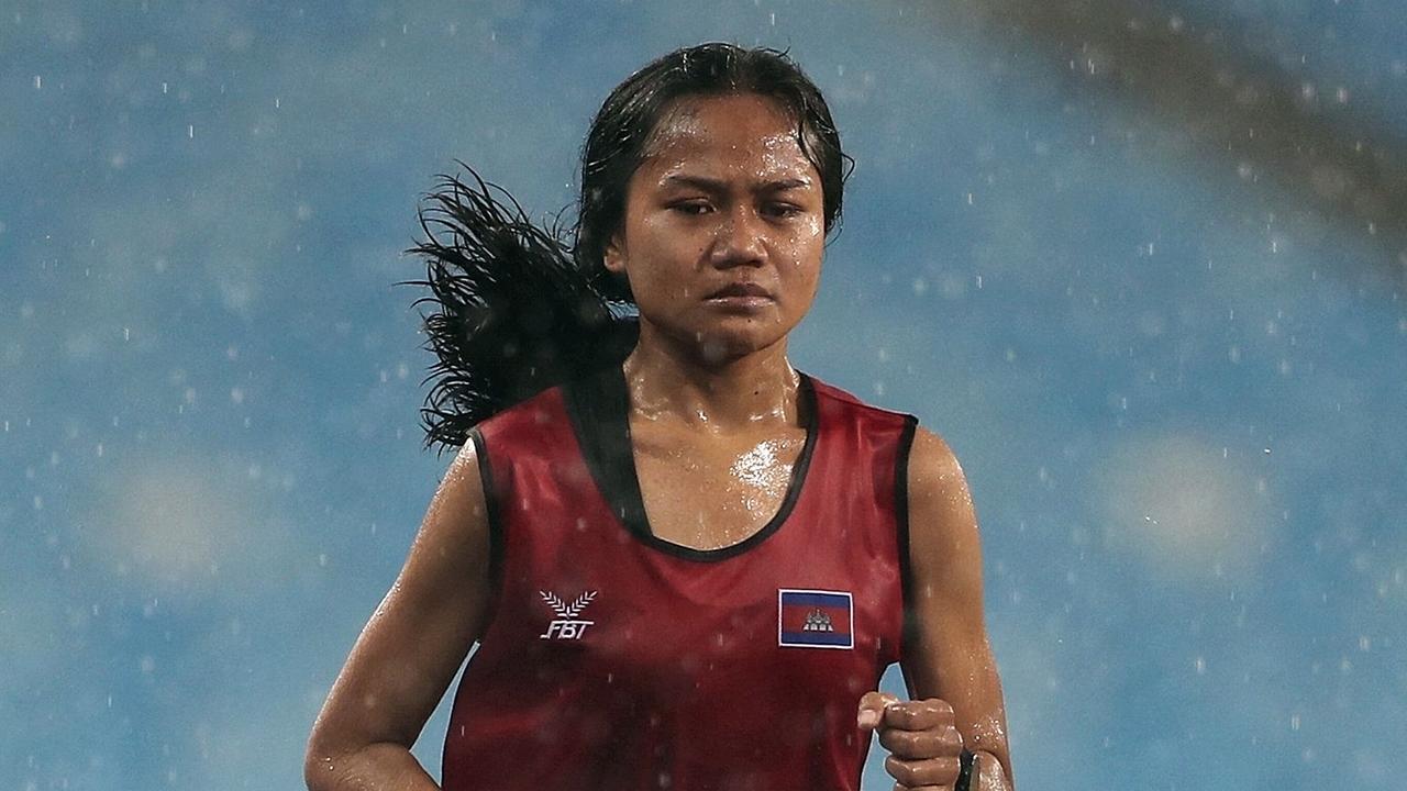 Cambodian runner comes last in torrential rain, but wins heart of