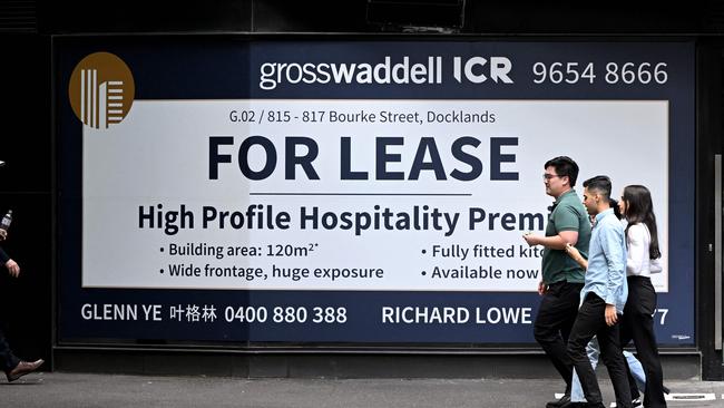 People walk past a sign advertising a retail space for lease in Melbourne. Picture: William West / AFP