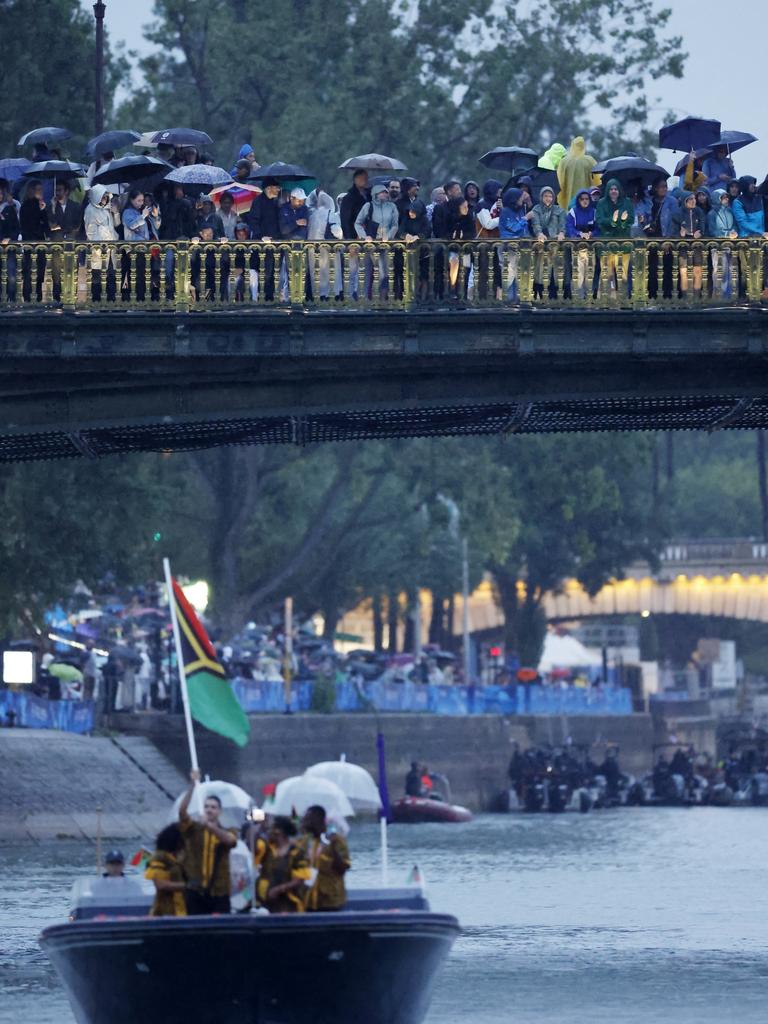 Spectators wearing rain ponchos on the banks of the river Seine. Picture: Clodagh Kilcoyne-Pool/Getty Images