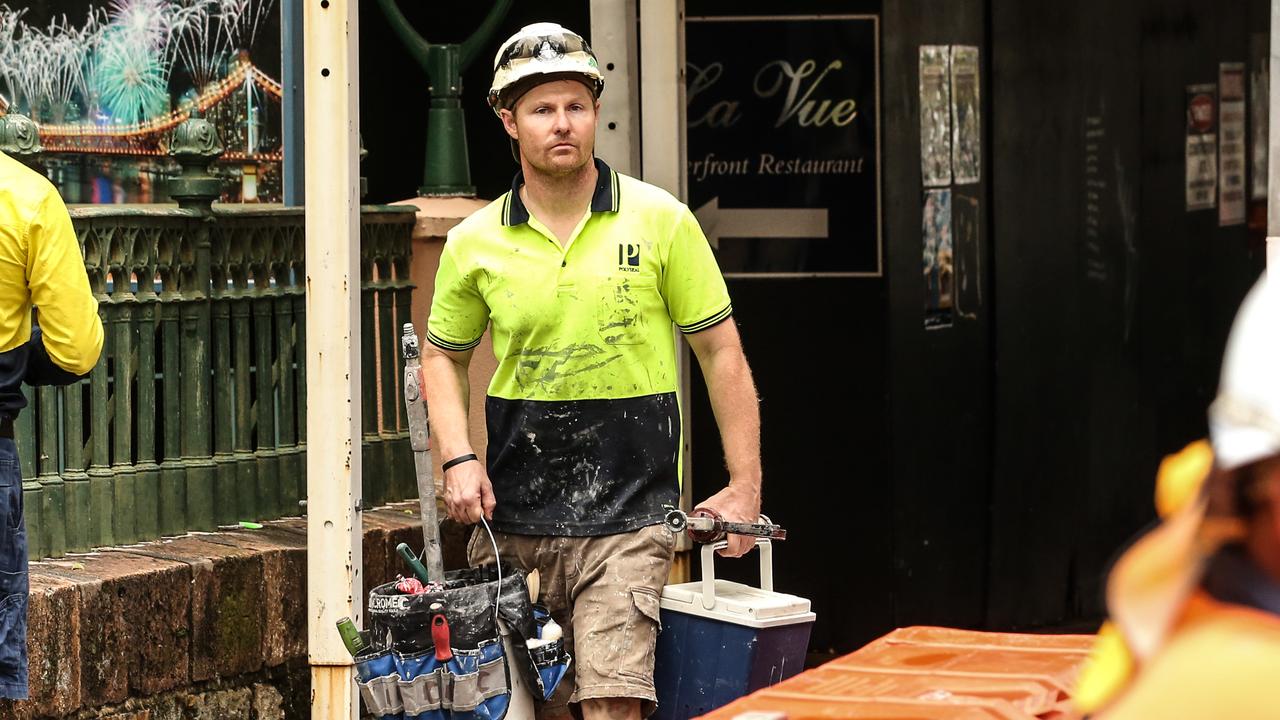 Workers leave the Probuild worksite on 443 Queen Street. Picture: Zak Simmonds